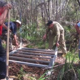 Installing the base of the tank into the pad we had to dig.